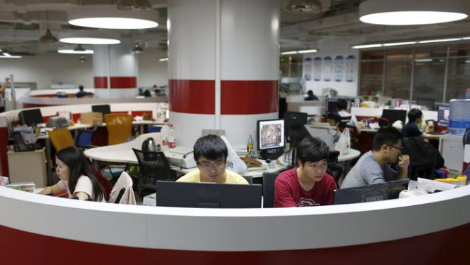 Young entrepreneurs work at an office area inside the University Students Venture Park, in Shanghai