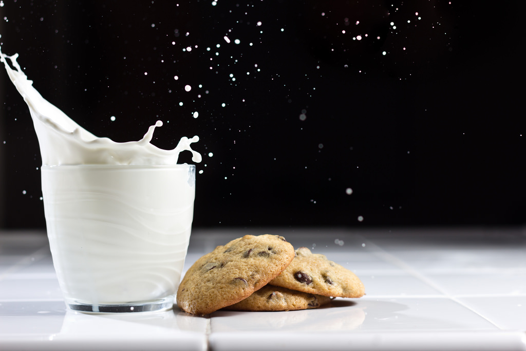 A milk glass  with cookies on display