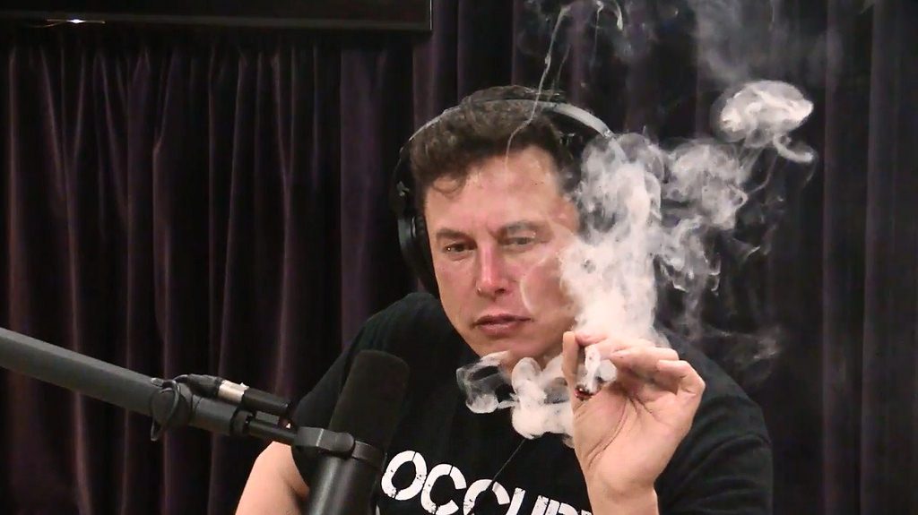 Elon Musk takes a marijuana puff 