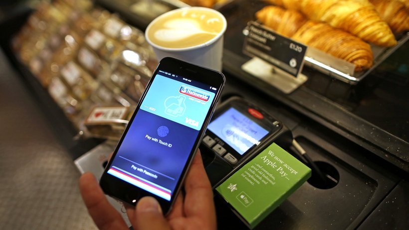 A consumer making online payment through mobile payment app Apple Pay