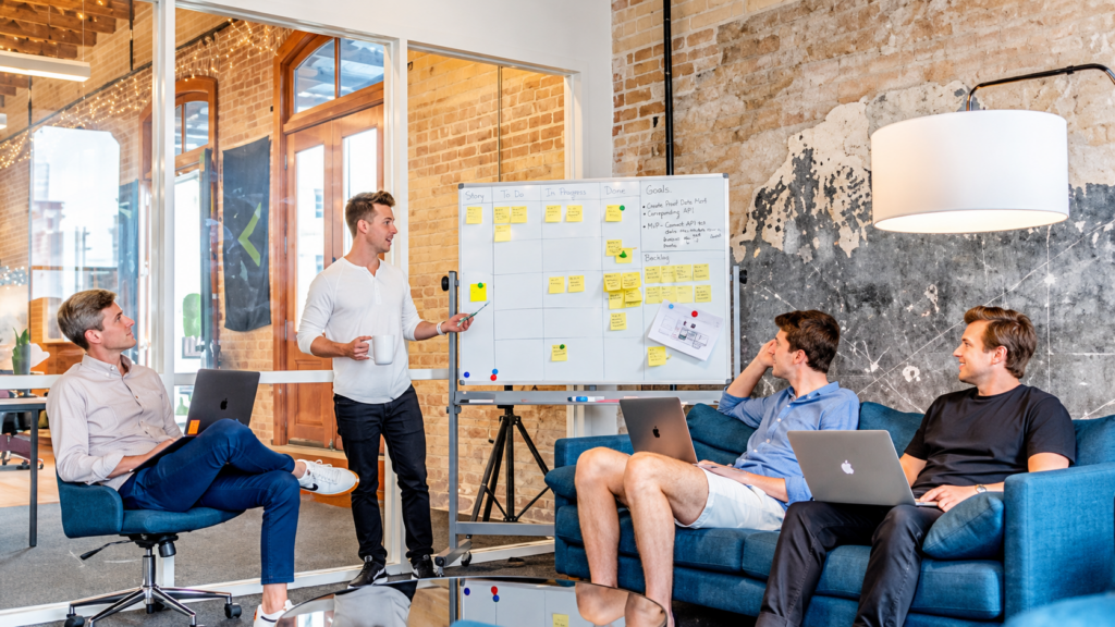 Startup team discussing email marketing campaigns in a collaborative office