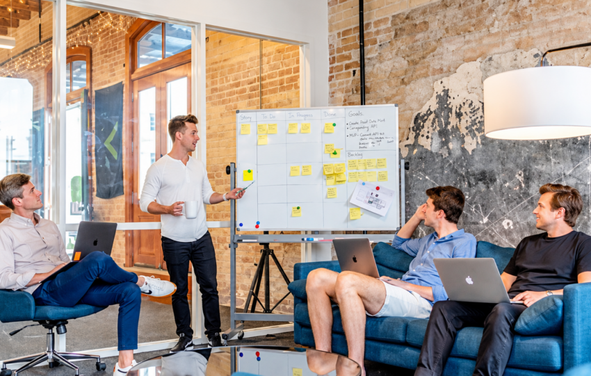Startup team discussing email marketing campaigns in a collaborative office